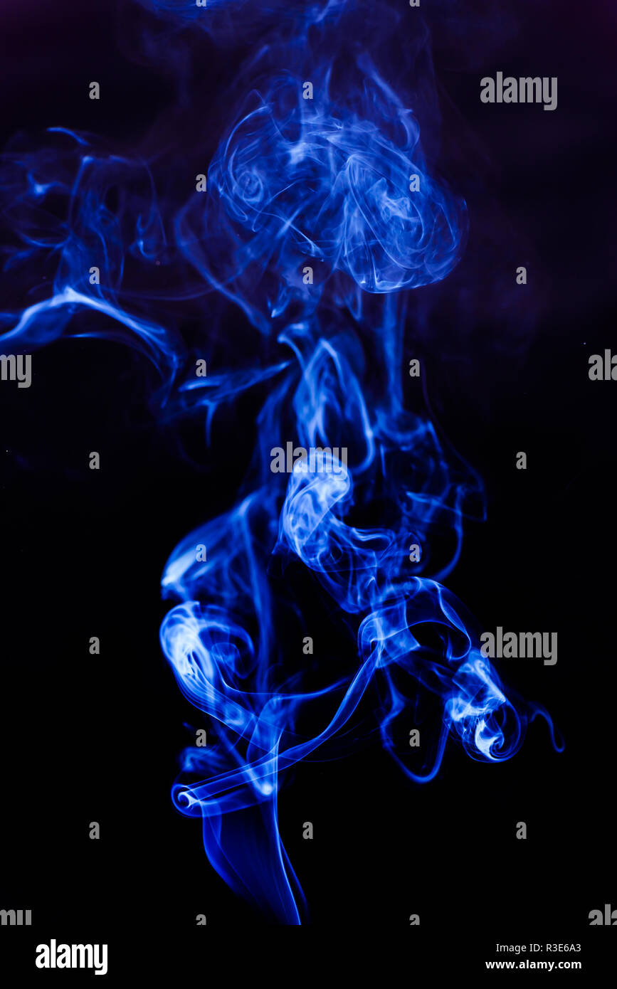 Blue smoke on a black background Stock Photo - Alamy