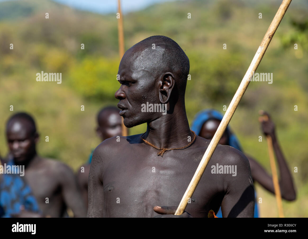 Suri tribe warrior during a donga stick fighting ritual, Omo valley, Kibish, Ethiopia Stock Photo