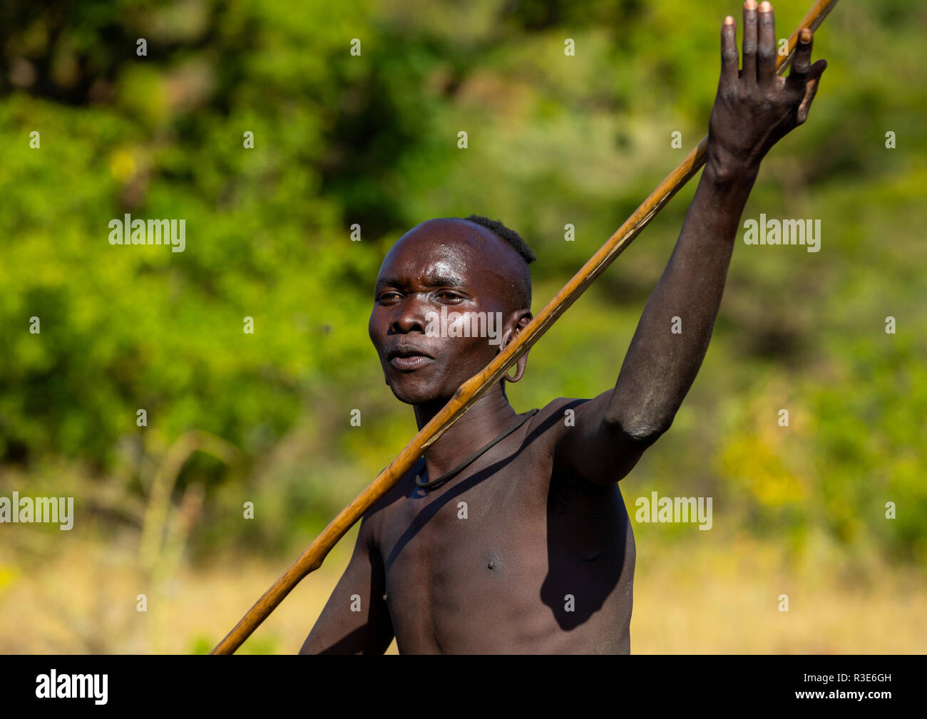 Suri tribe warrior during a donga stick fighting ritual, Omo valley, Kibish, Ethiopia Stock Photo