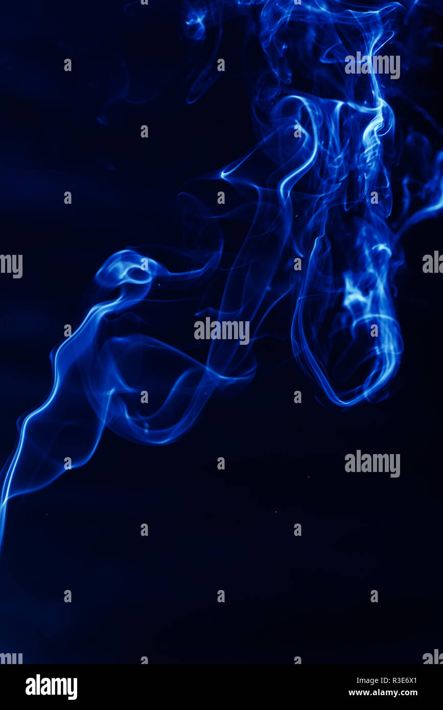 Blue smoke on a black background Stock Photo - Alamy