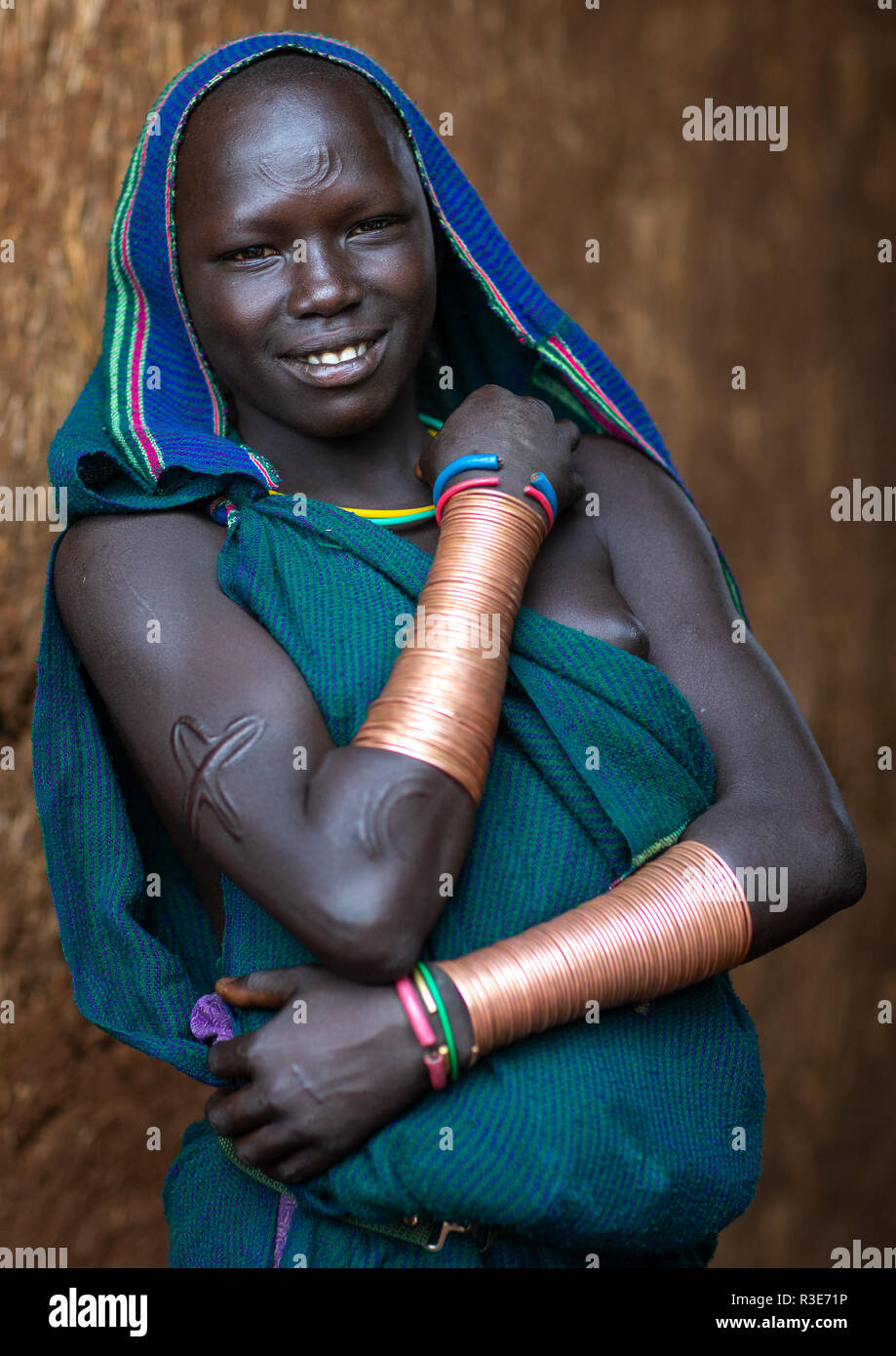 Portrait of a suri tribe woman with impressive bracelets, Omo valley