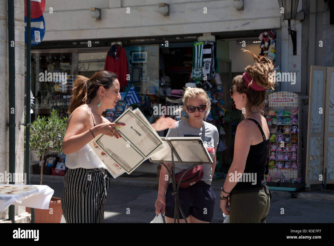 restaurant manageress talking to potential customers plaka athens greece Stock Photo