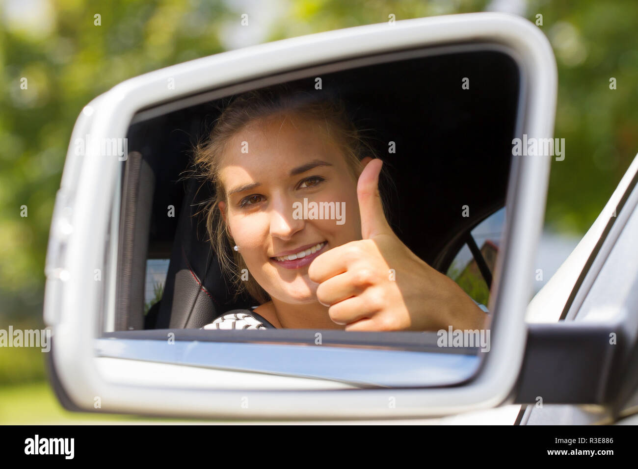 young female driver with thumb up Stock Photo