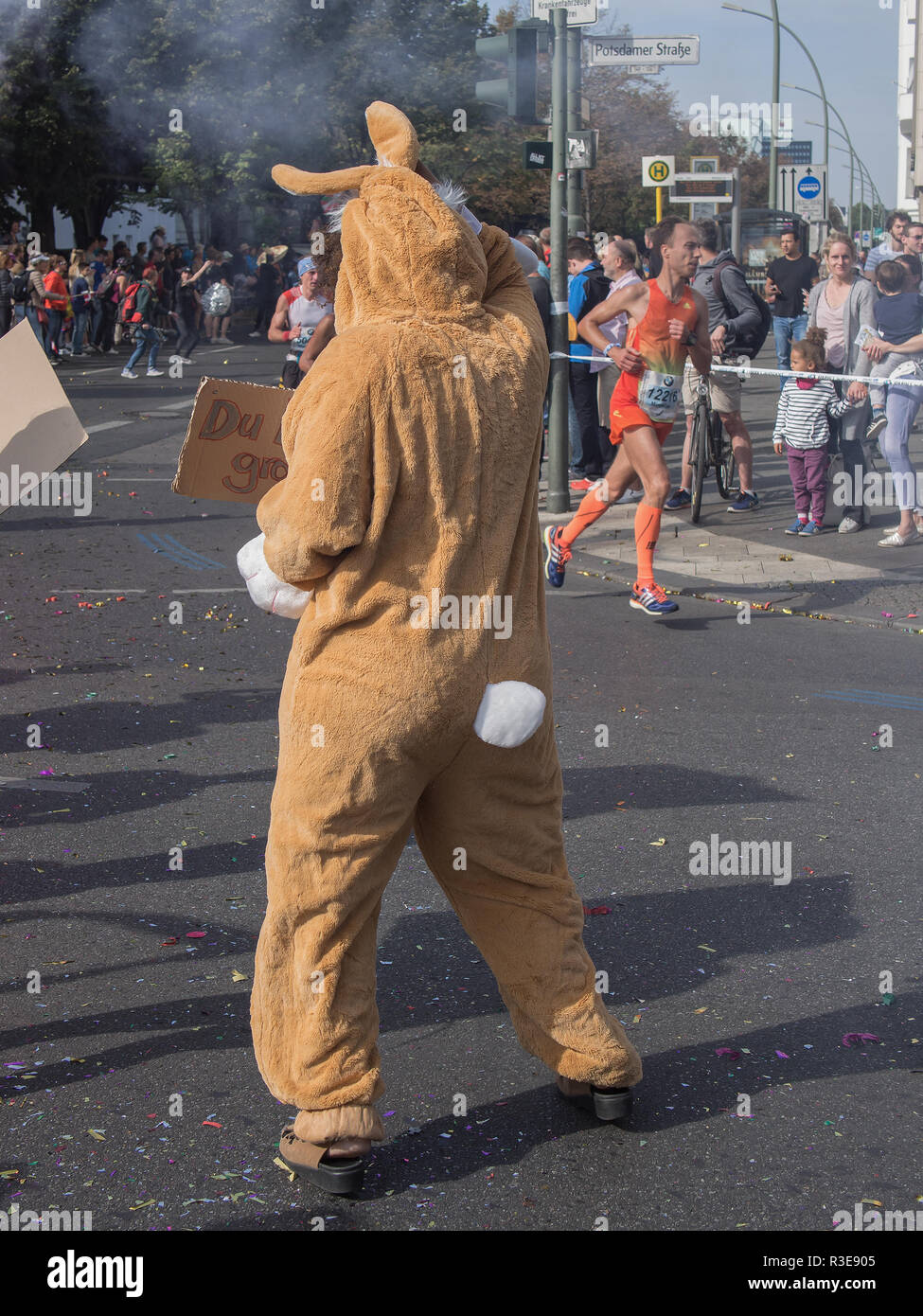 BERLIN, GERMANY - SEPTEMBER 25, 2016: Spectator With A Rabbit Costume And Runners At Berlin Marathon 2016 Stock Photo