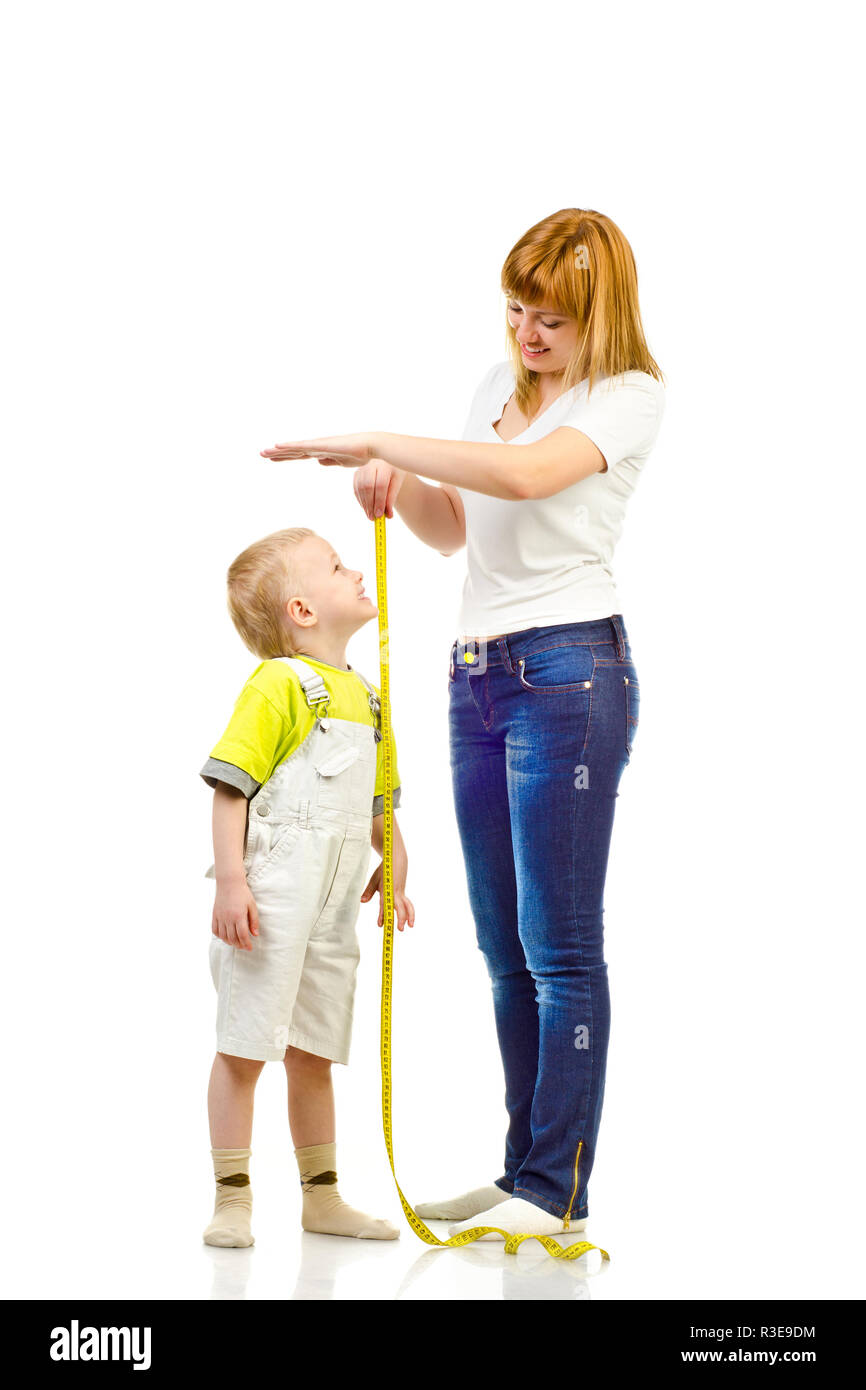 woman measuring child isolated on a white background Stock Photo
