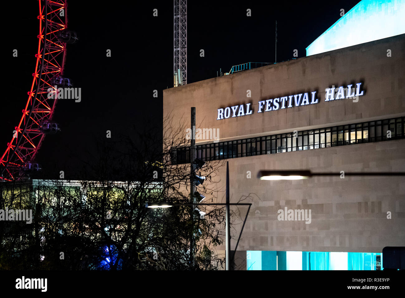 A view of the Royal Festival Hall next to the London Eye at night Stock Photo