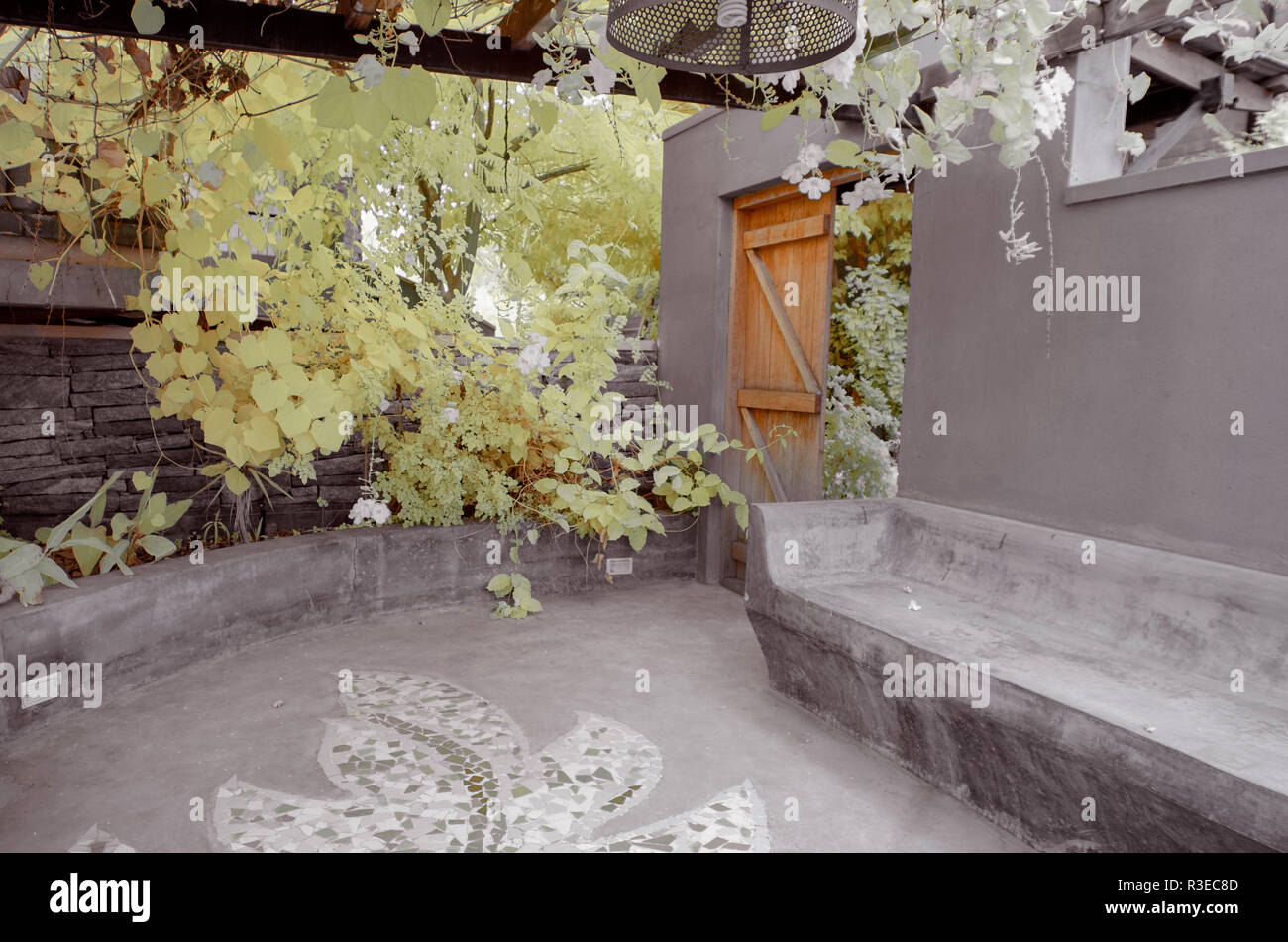 Infrared image of a patio with seats and hanging plants from the