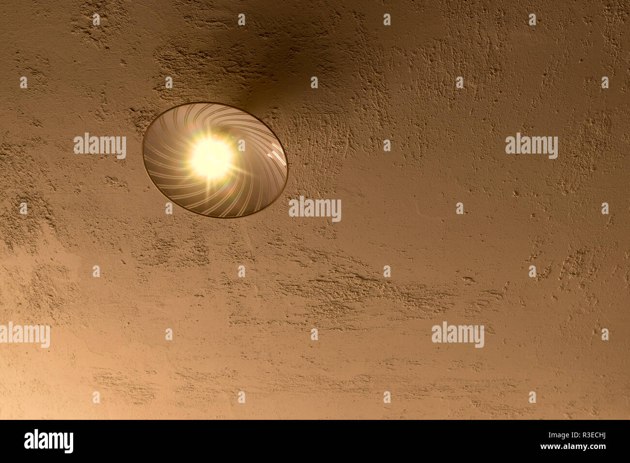 A Ceiling Lamp On A Rough Plastered Concrete Ceiling With