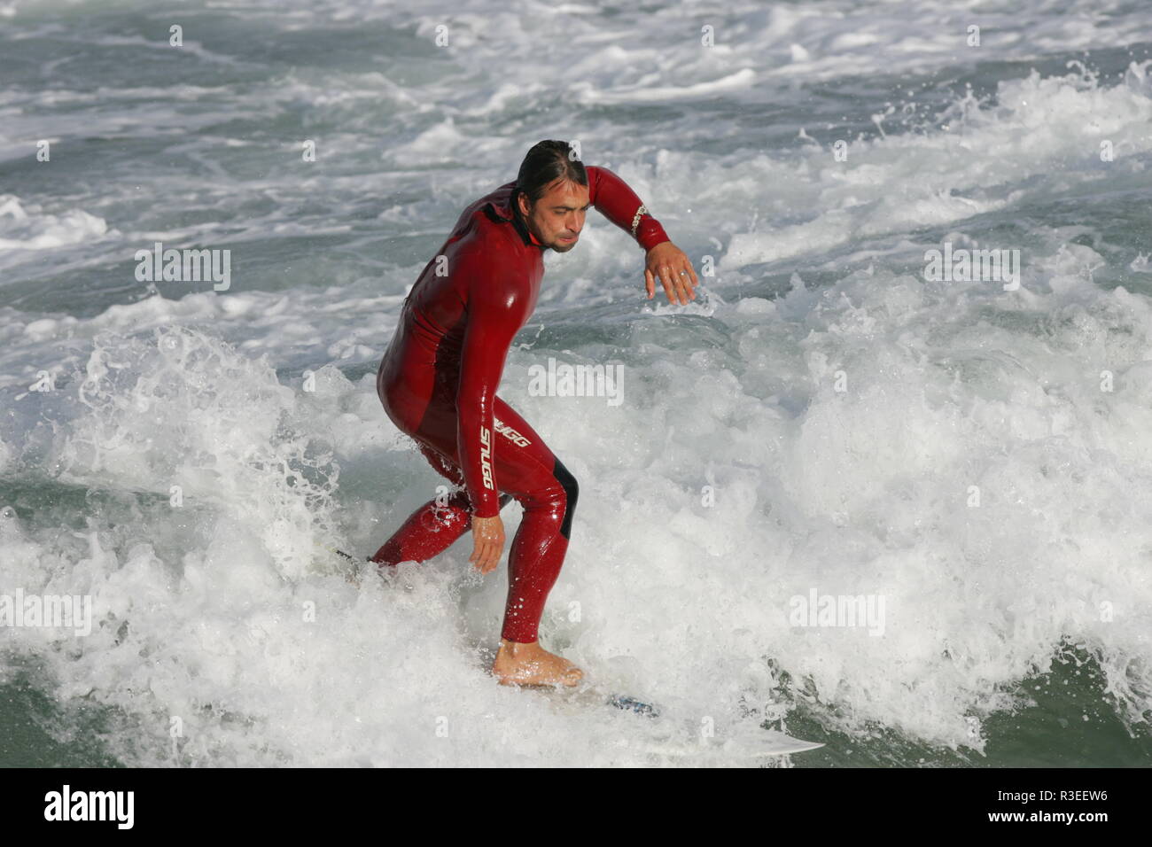 Surfing fun with red wetsuit Cornwall Stock Photo Alamy