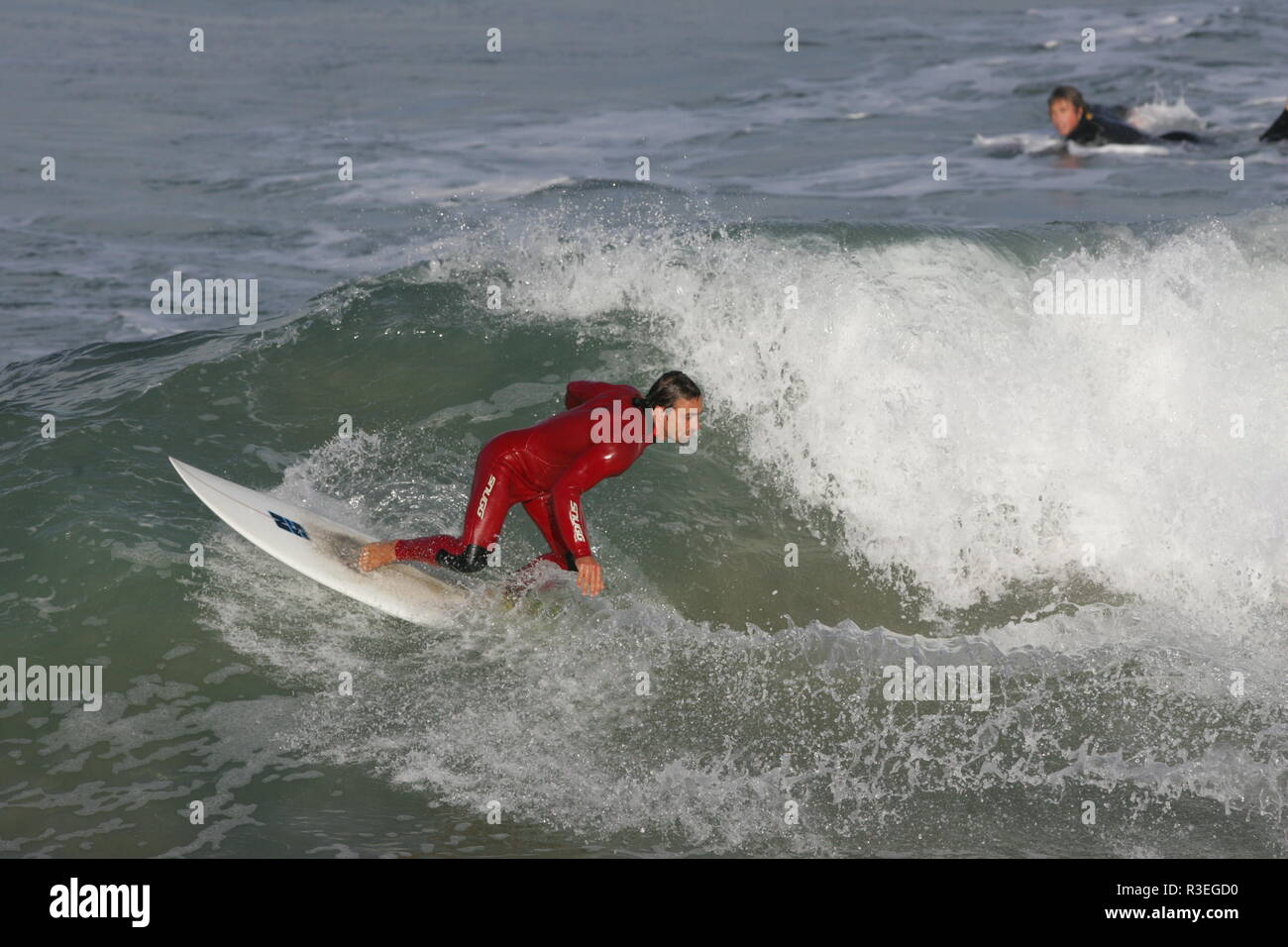 Surfing fun with red wetsuit Cornwall Stock Photo Alamy