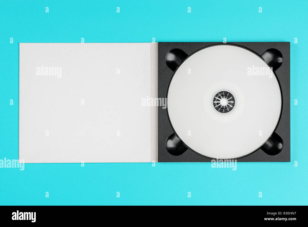 White cd in black case on pastel green background Stock Photo