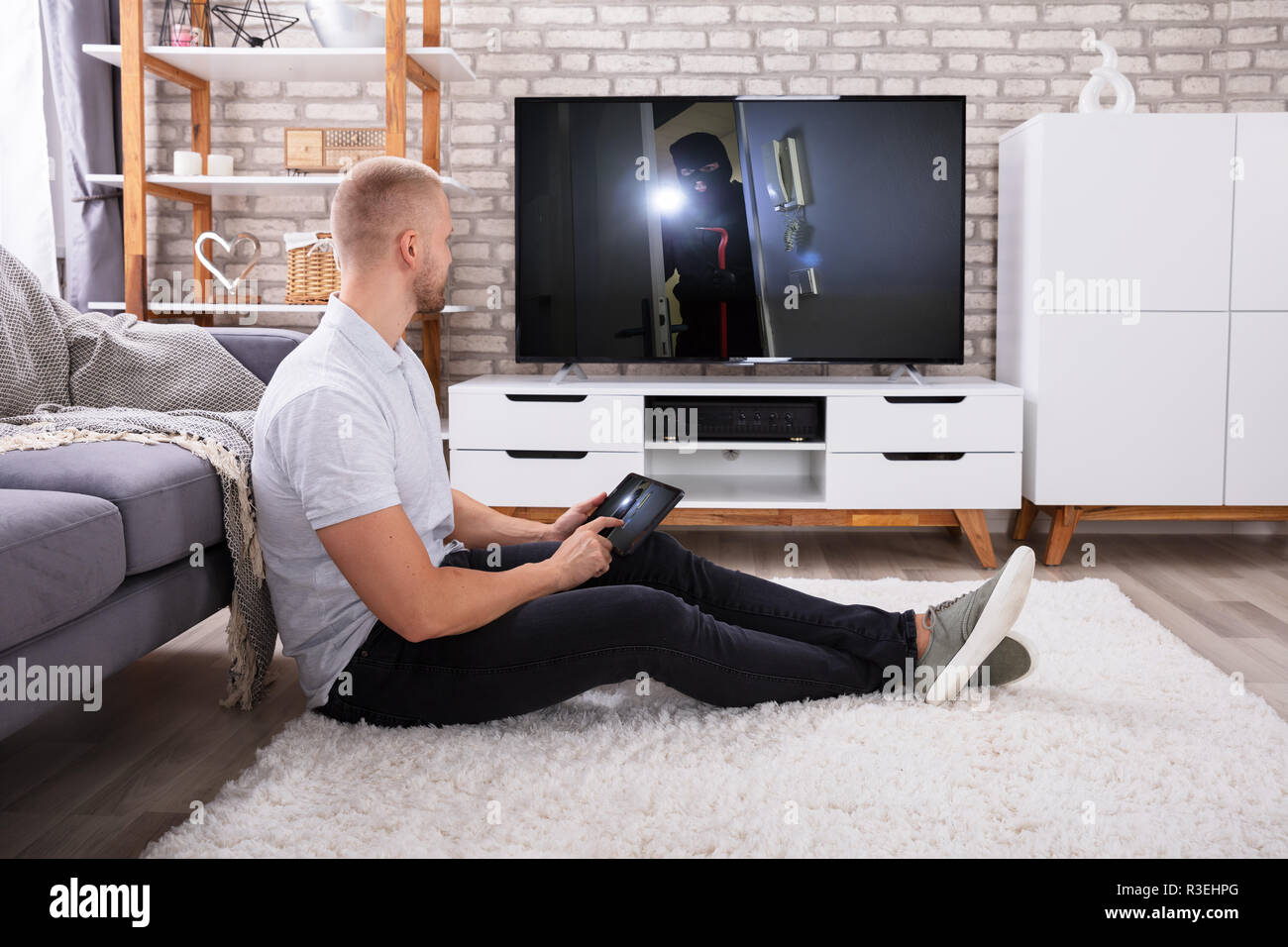 Man Streaming Television Channel Through Wireless Connection On Digital Tablet Stock Photo