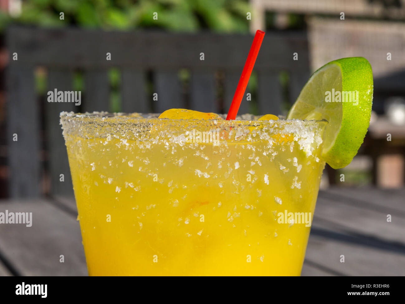 yellow colored cocktail with salt and lime on the rim Stock Photo