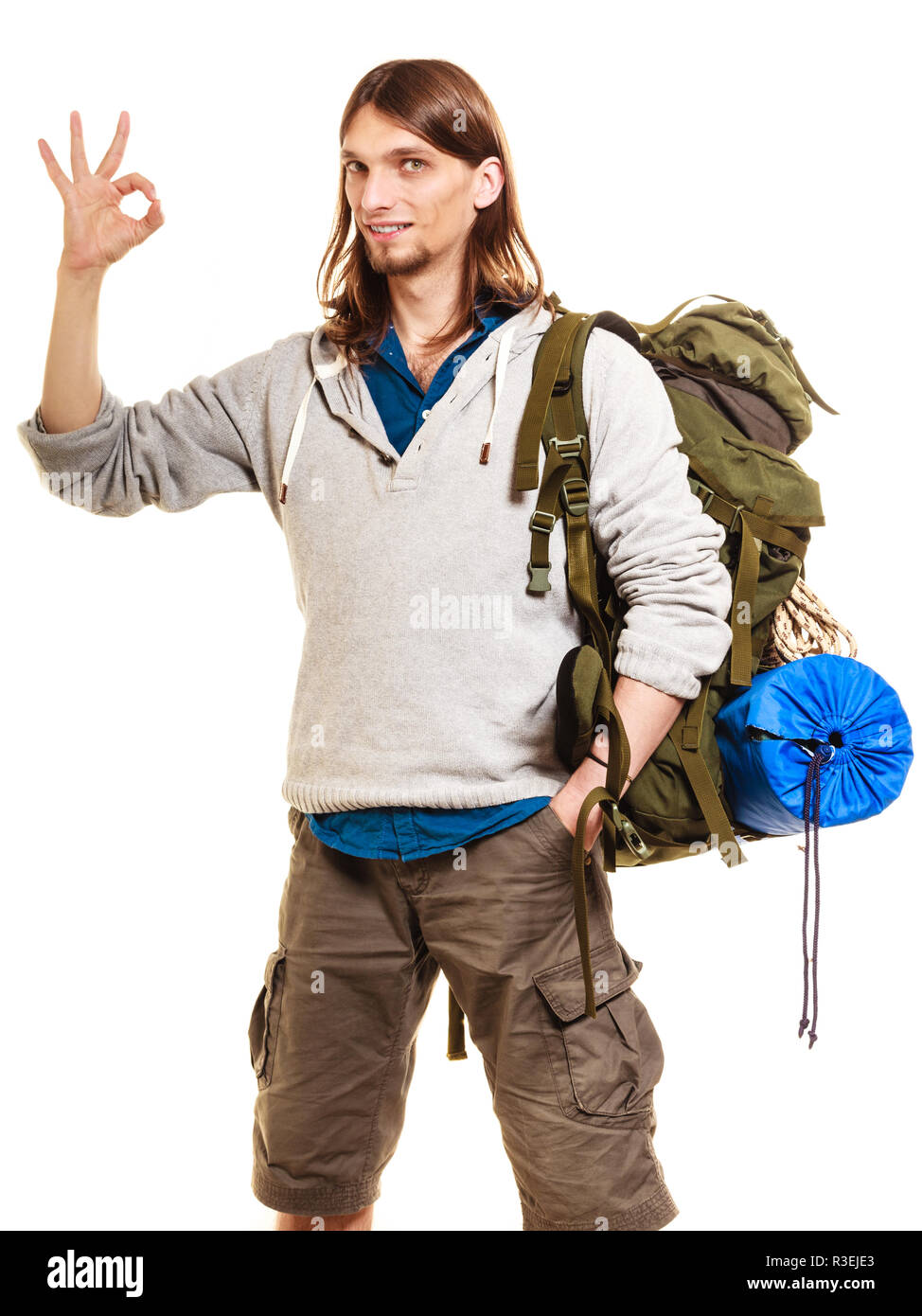 Portrait of man tourist backpacker on trip showing ok gesture. Young guy hiker backpacking. Summer vacation travel. Isolated on white background. Stock Photo