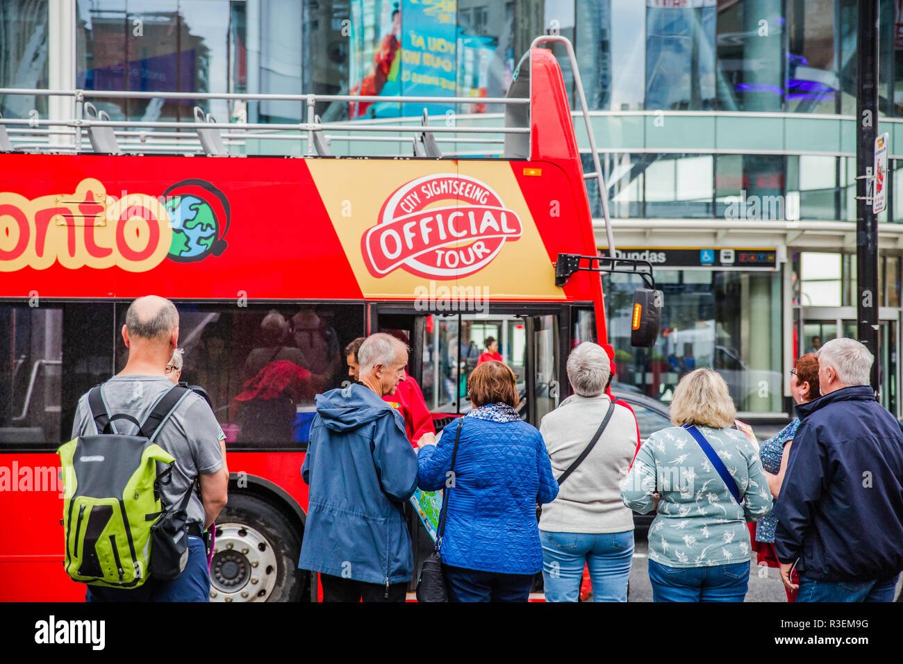 tourists lining up for toronto sightseeing bus red double decker tour bus Stock Photo