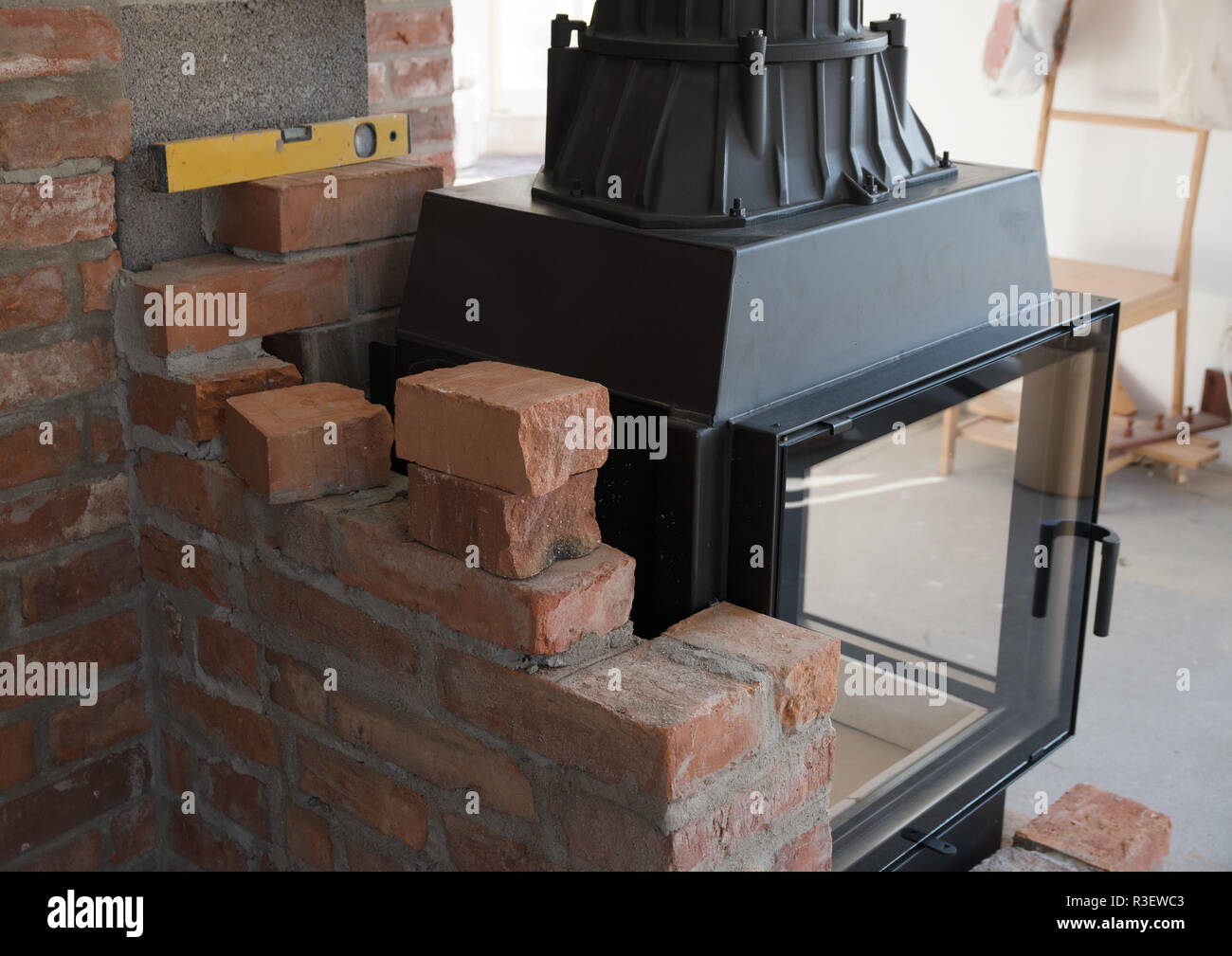 COSY decorating letters against a rustic brick wall above a wood burning  stove Stock Photo - Alamy