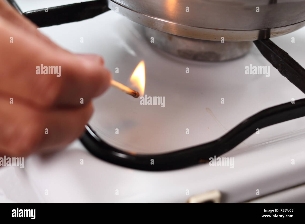Light gas stove with match Stock Photo Alamy