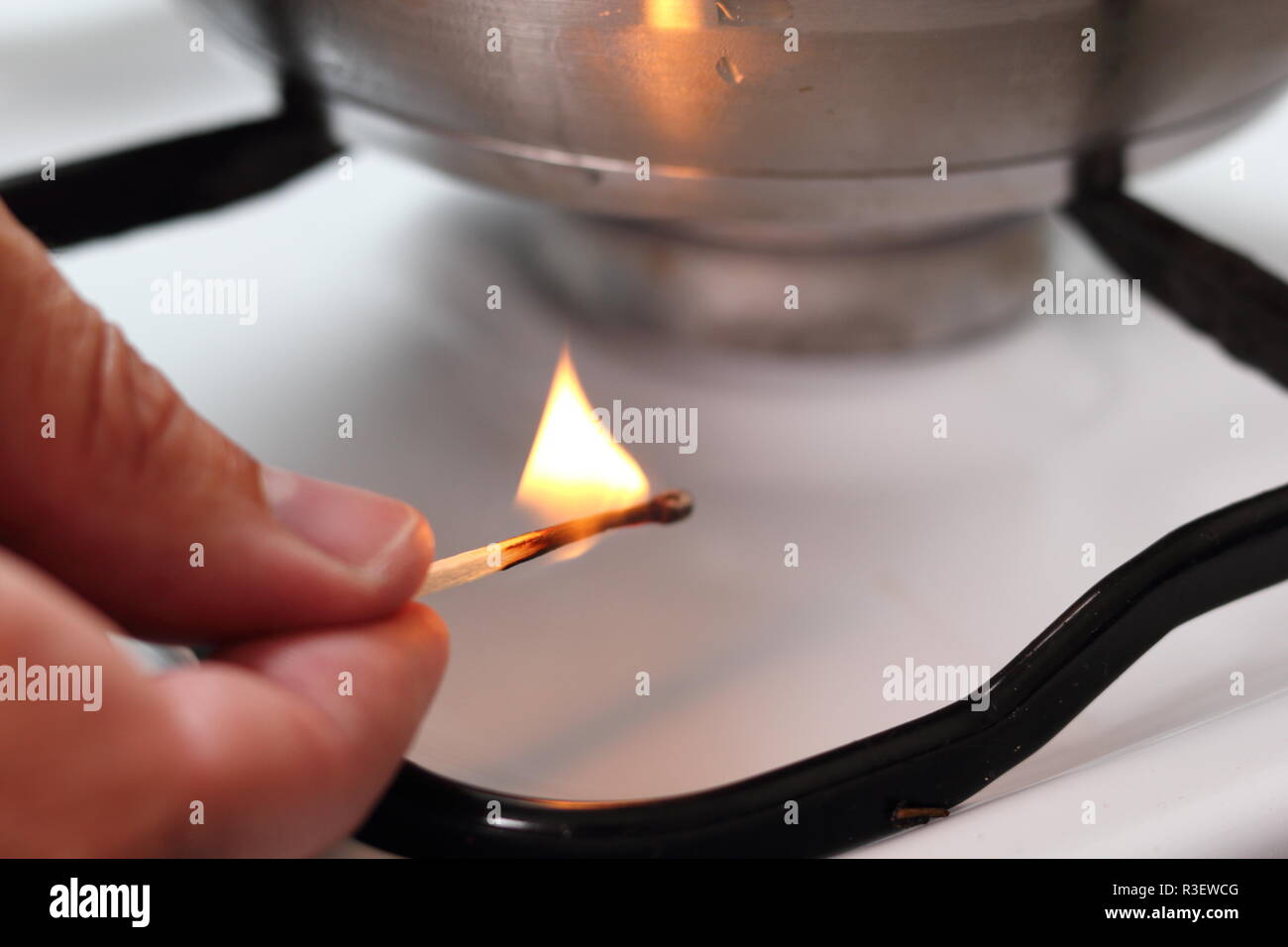Light gas stove with match Stock Photo Alamy