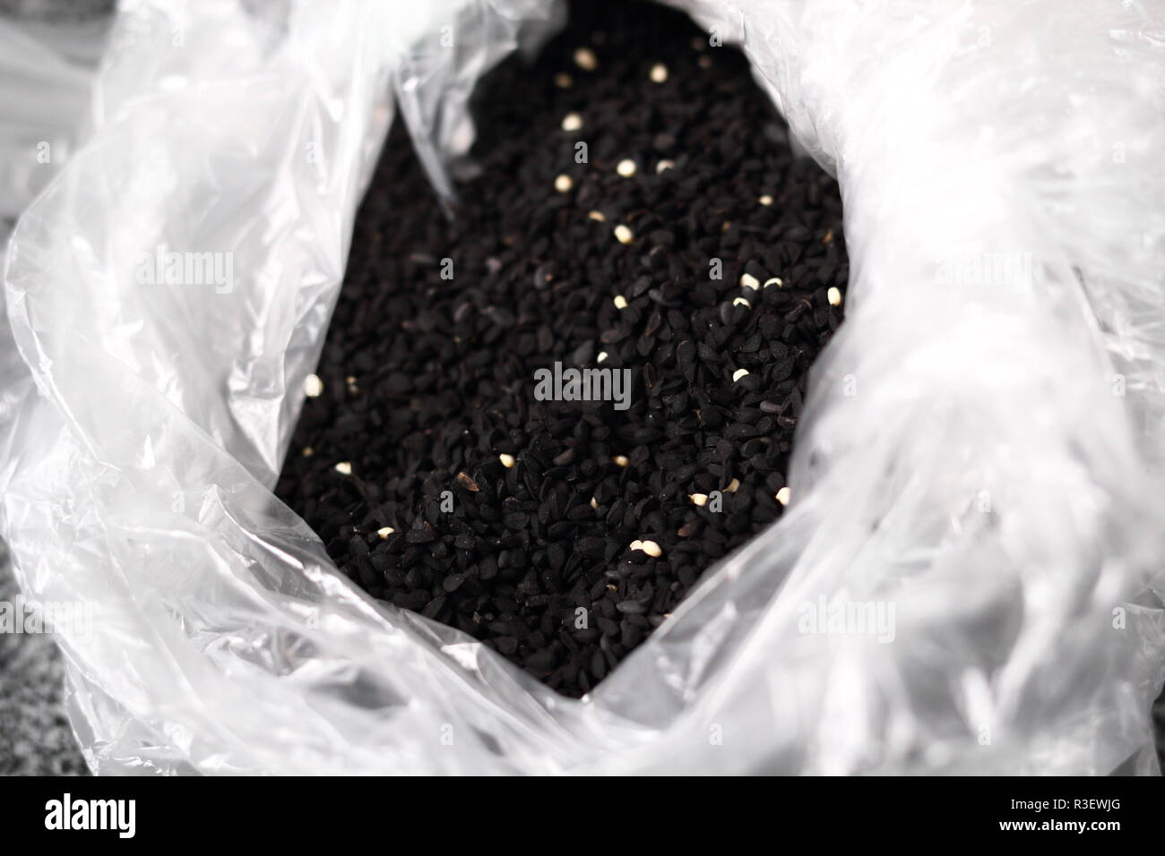 Black cumin seeds in plastic bag Stock Photo