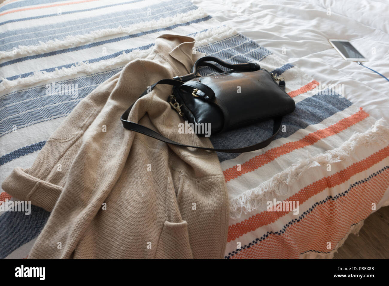 Bag left on bed in hotel room Stock Photo