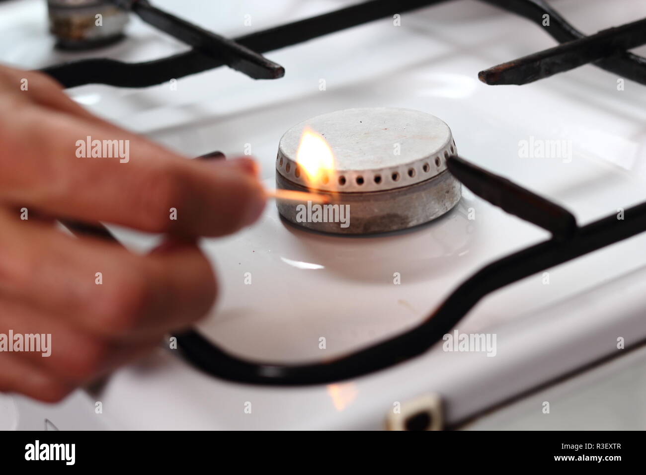 Light gas stove with match Stock Photo