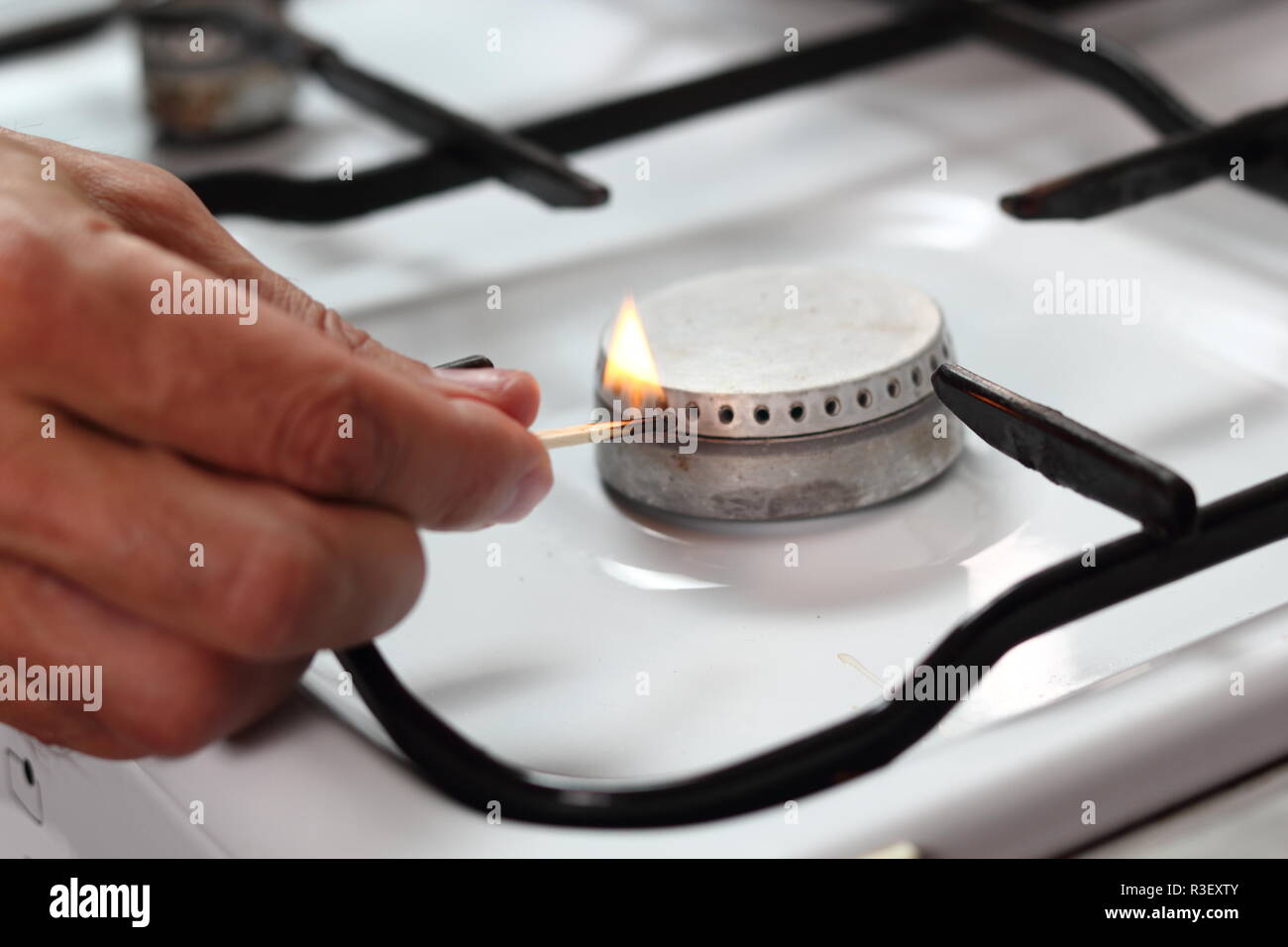 Light gas stove with match Stock Photo Alamy