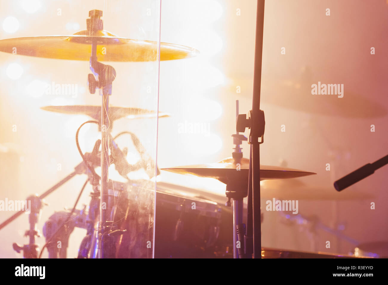 Live rock music photo background, rock drum set  with cymbals in bright strobe  lights. Close-up photo, soft selective focus Stock Photo
