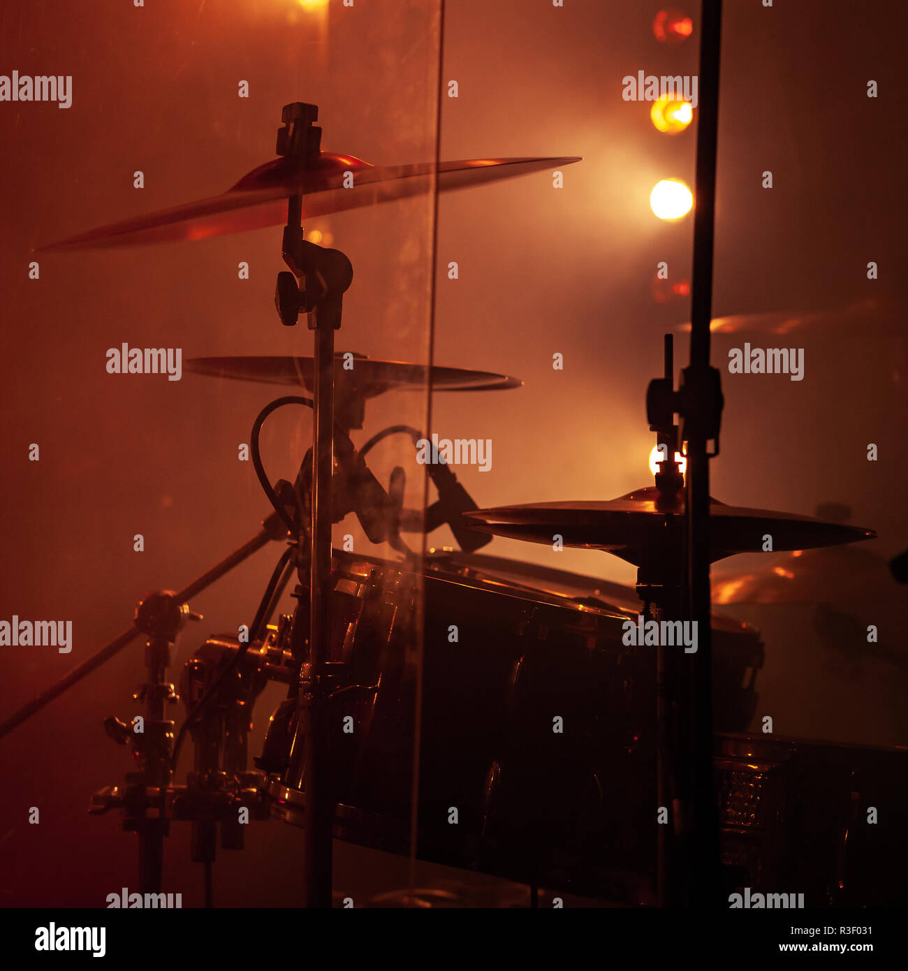 Live rock music photo background, rock drum set  with cymbals in smoke and red lights. Close-up photo, soft selective focus Stock Photo