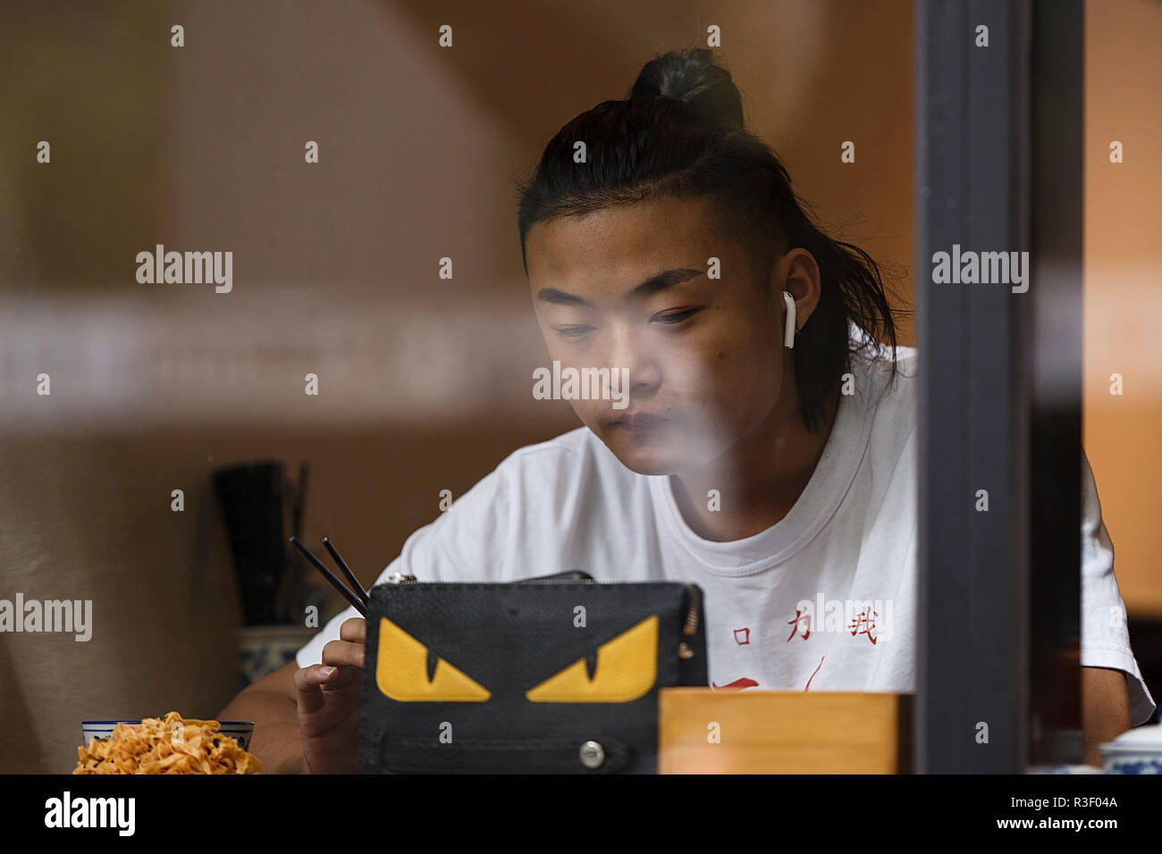 Melbourne, Australia-October 23,2018: Young asian boy eats at a melbourne restaurant. Stock Photo