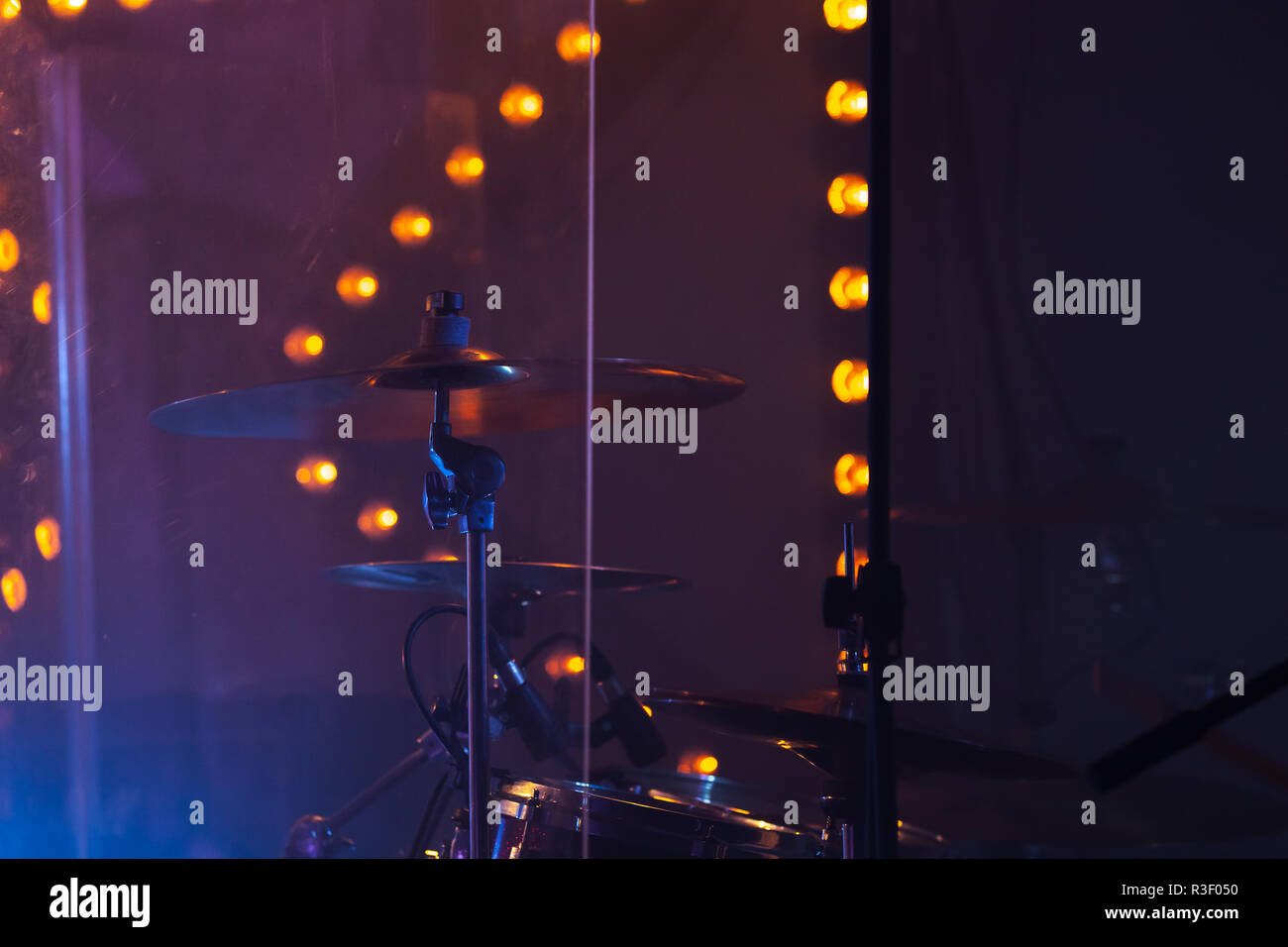 Live rock music photo background, rock drum set  with cymbals in dark stage lights. Close-up photo, soft selective focus Stock Photo
