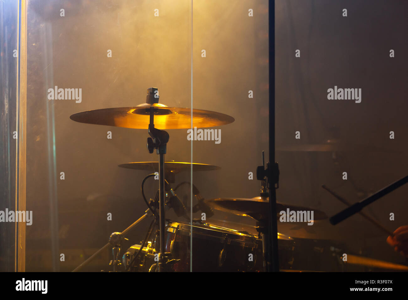 Live rock music photo background, rock drum set  with cymbals in warm stage lights. Close-up photo, soft selective focus Stock Photo