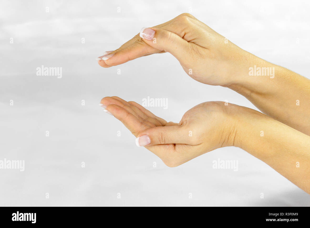 two young female hands hovering above the other and seem to include anything. Stock Photo