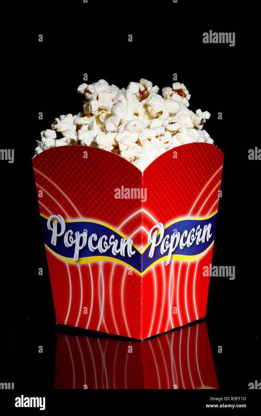 Filled red popcorn box on black background Stock Photo Alamy