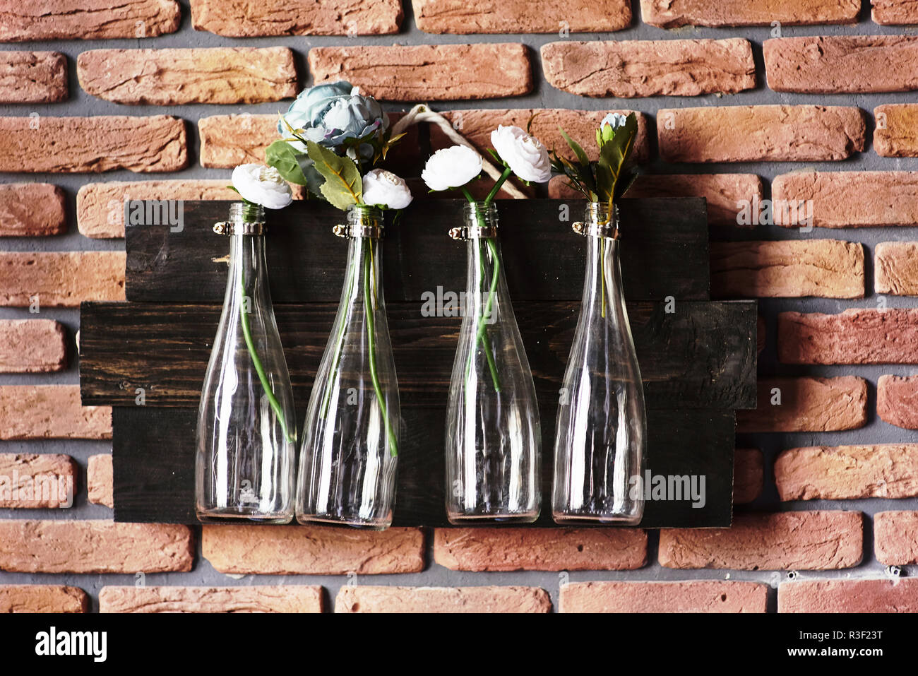 Interior Decoration With Bottles On Brick Wall With Flowers Great