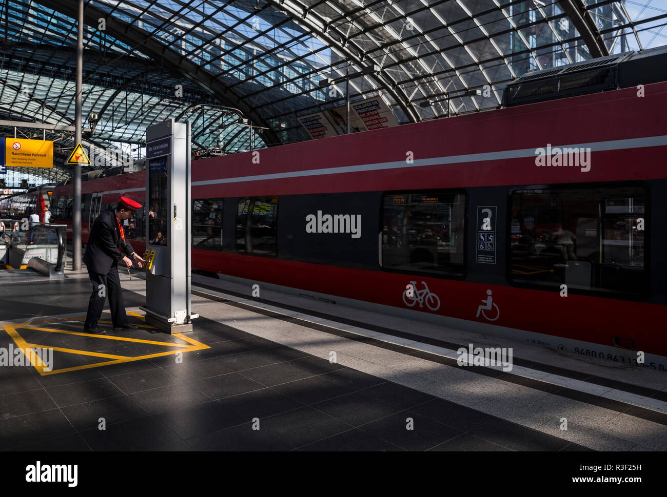 A railway worker at the main train station (Hauptbahnhof), Berlin, Germany. Stock Photo