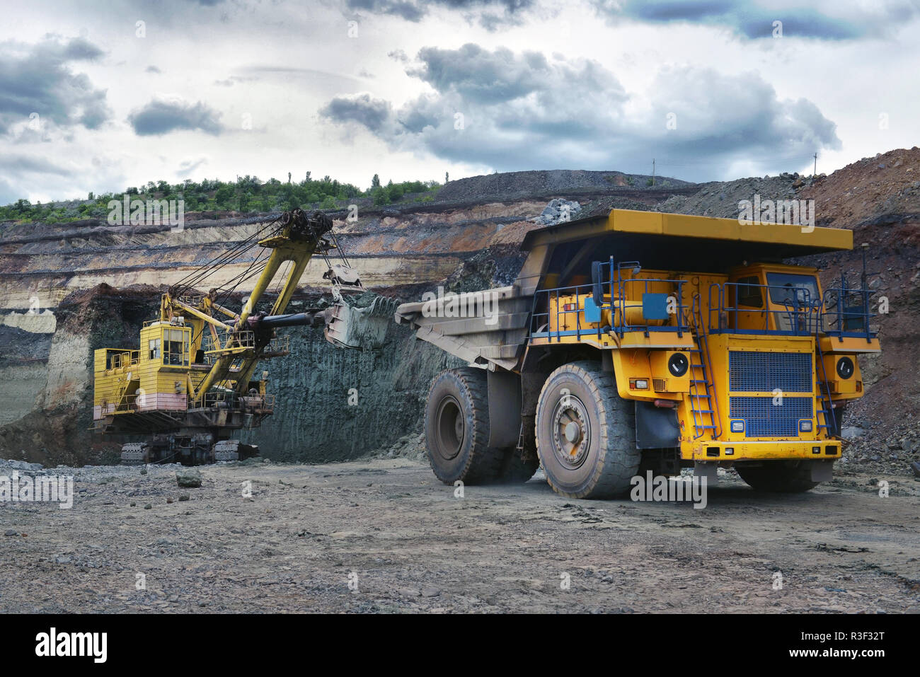 Large quarry dump truck. Loading the rock in the dumper. Loading coal into body work truck. Mining truck mining machinery, to transport coal from open Stock Photo