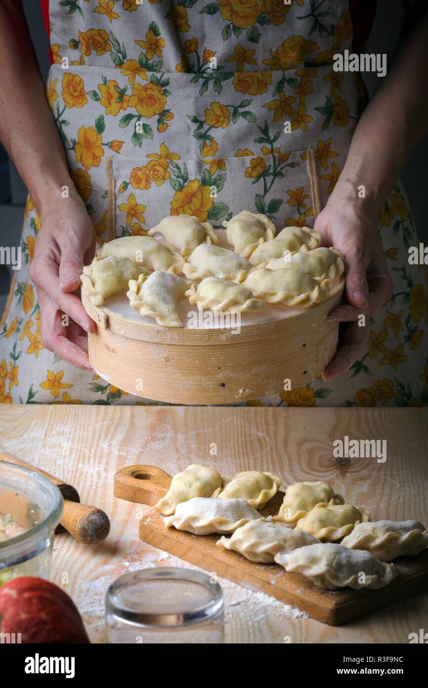 Ukrainian traditional bakery products - Making pierogies by female ...