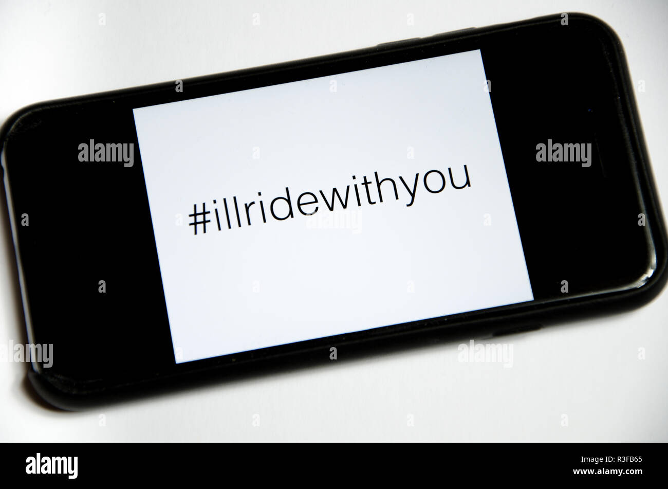 smartphone with hashtag illridewithyou Stock Photo