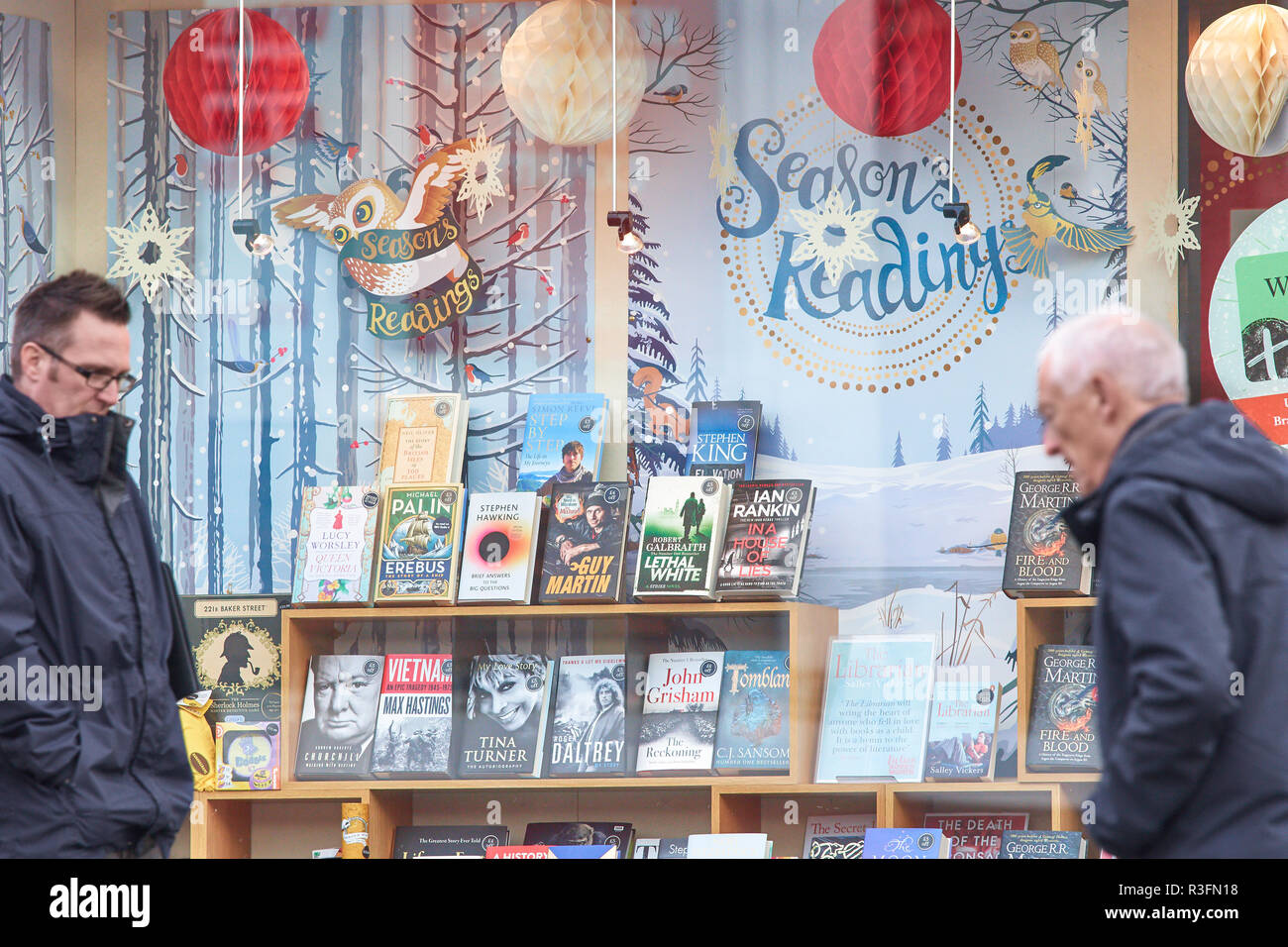 Display of books in a window with decorations for christmas