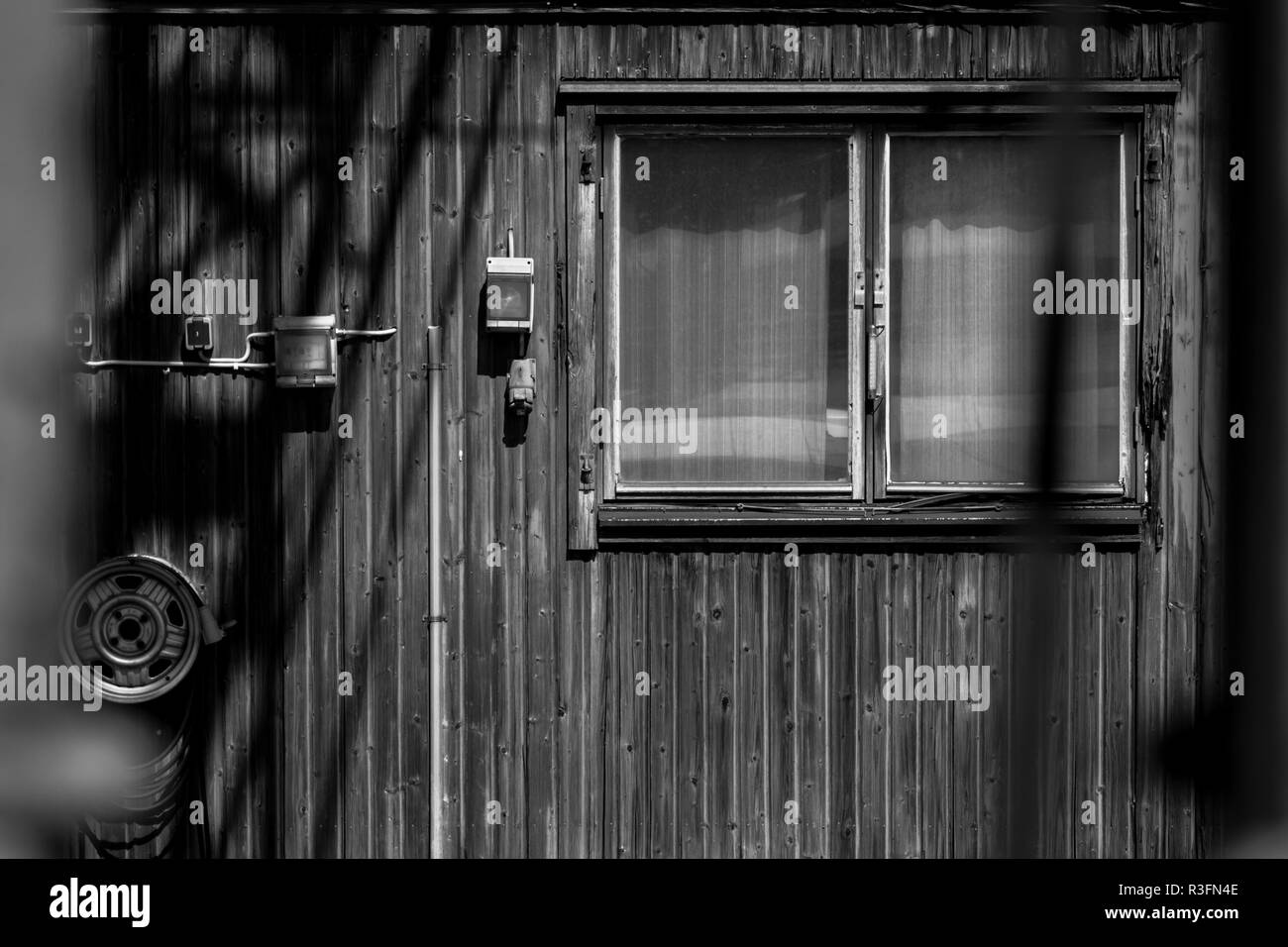 A facade with windows of a small wooden house in black and white, Kil, Sweden Stock Photo