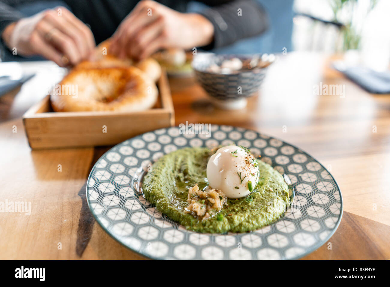 Hummus with nuts and boiled egg and olive oil. It is served in the