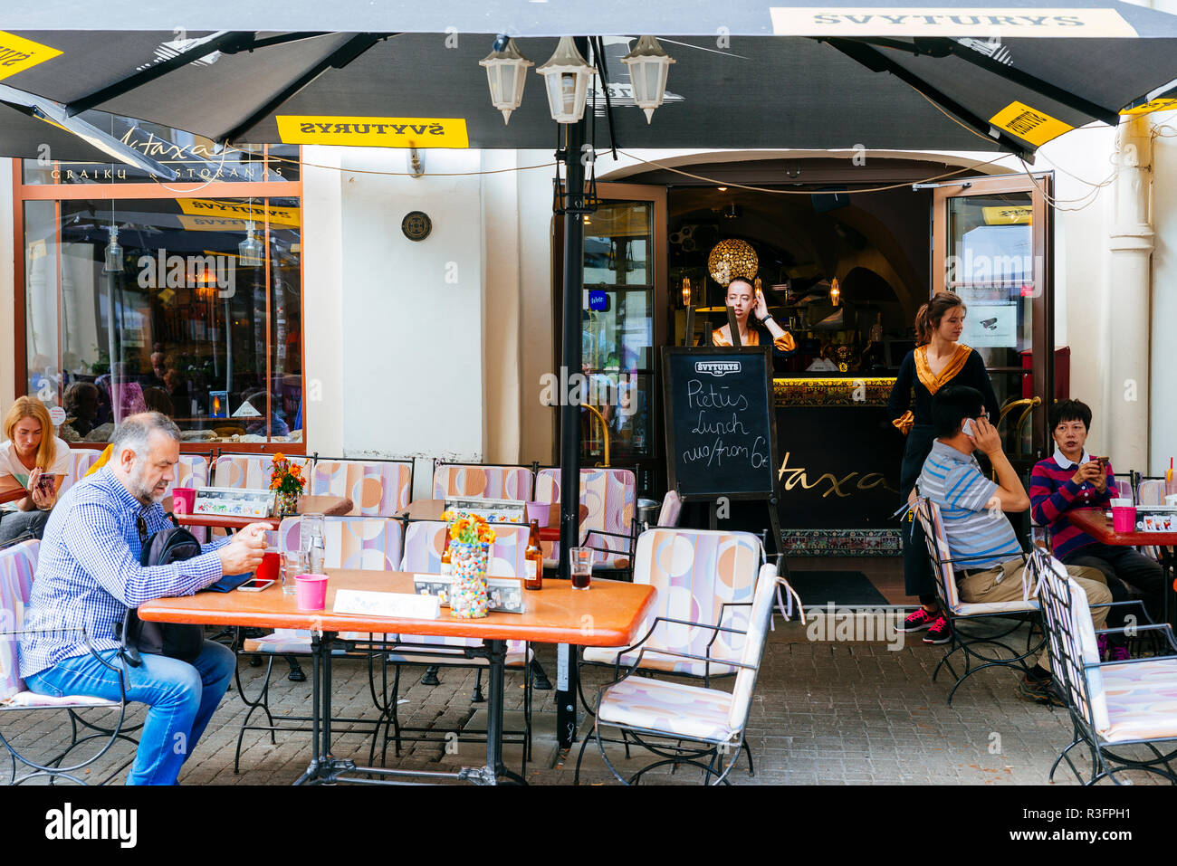 Lively terrace on Pilies g. Street, Vilnius, Vilnius County, Lithuania, Baltic states, Europe. Stock Photo