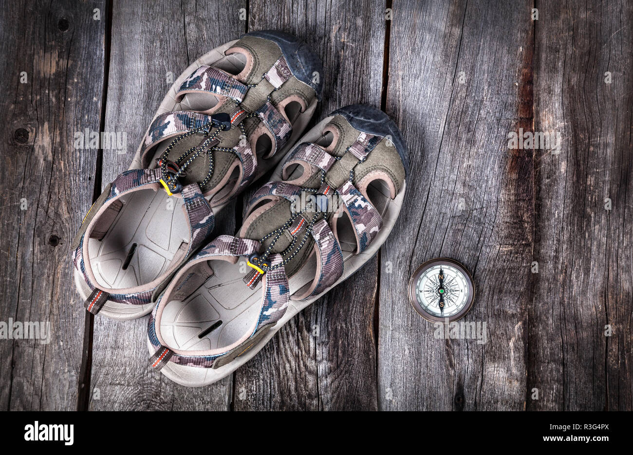Shoes and compass traveler outfit on the wooden background Stock Photo