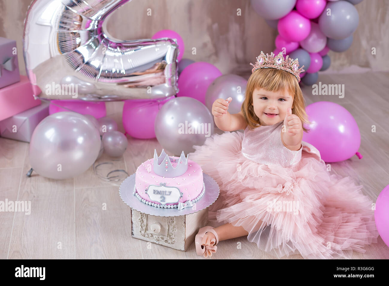 Princess Baby Girl Celebrating Life Event Wearing Golden Crown And Pink Airy Dress Cute Girl Posing In Pastel Colors Studio Shoot With Air Baloons An Stock Photo Alamy