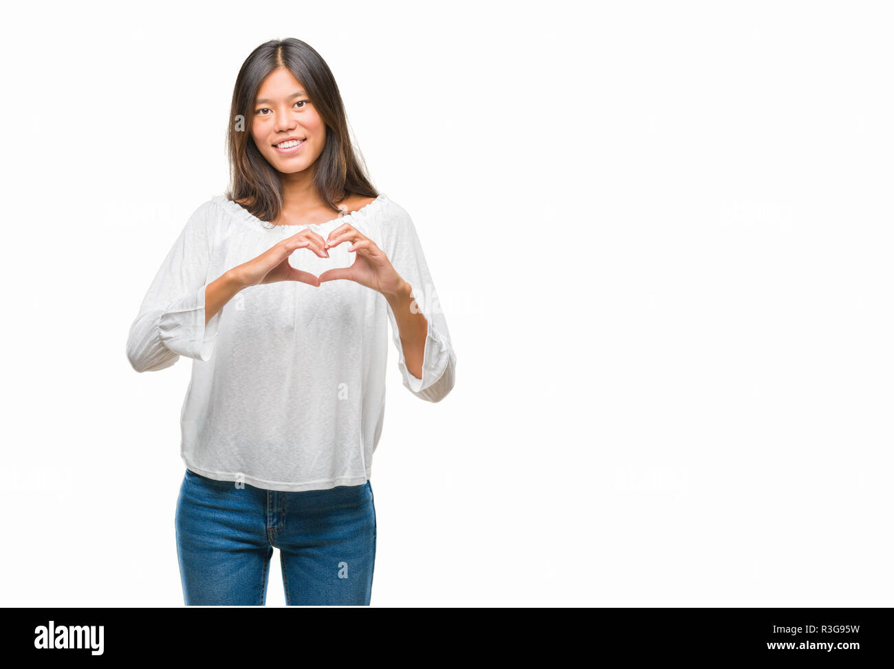 Young asian woman over isolated background smiling in love showing ...