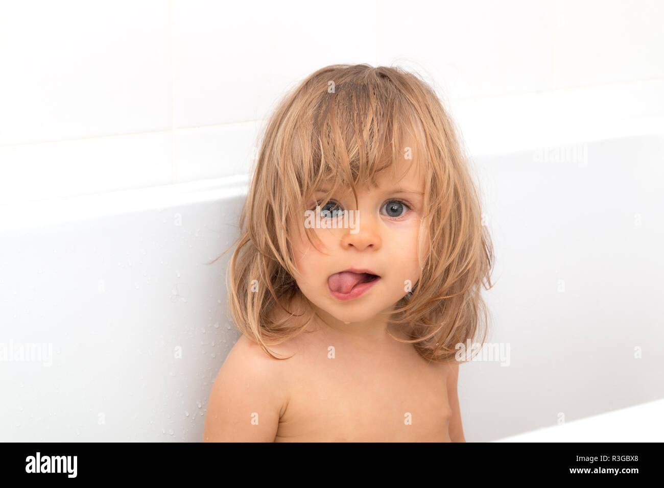 Little girl with blond wet hair laughs and shows tongue on the white backgrond. Fun bathing children. Positive hygiene. Independent child. Toddler loo Stock Photo - Alamy Little girl with blond wet hair laughs and shows tongue on the white backgrond. Fun bathing children. Positive hygiene. Independent child. Toddler loo Stock Photo - Alamy