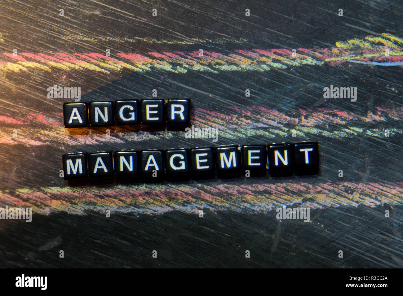 Anger Management on wooden blocks. Cross processed image with ...