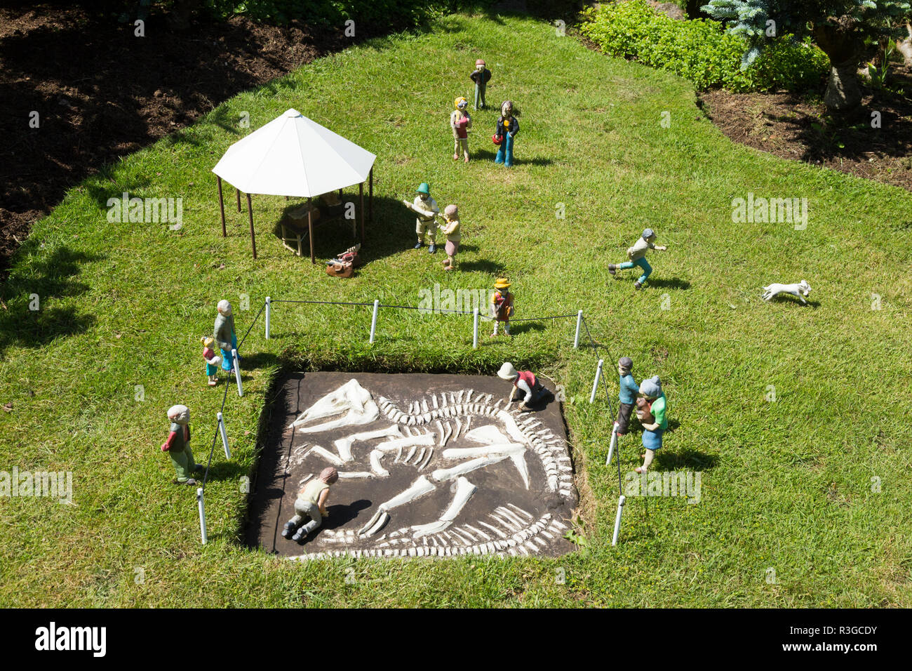 Miniature recreation / creation of an archaeological dig for a dinosaur skeleton at site inside the Model Village. Godshill, Ventnor, Isle of Wight UK Stock Photo
