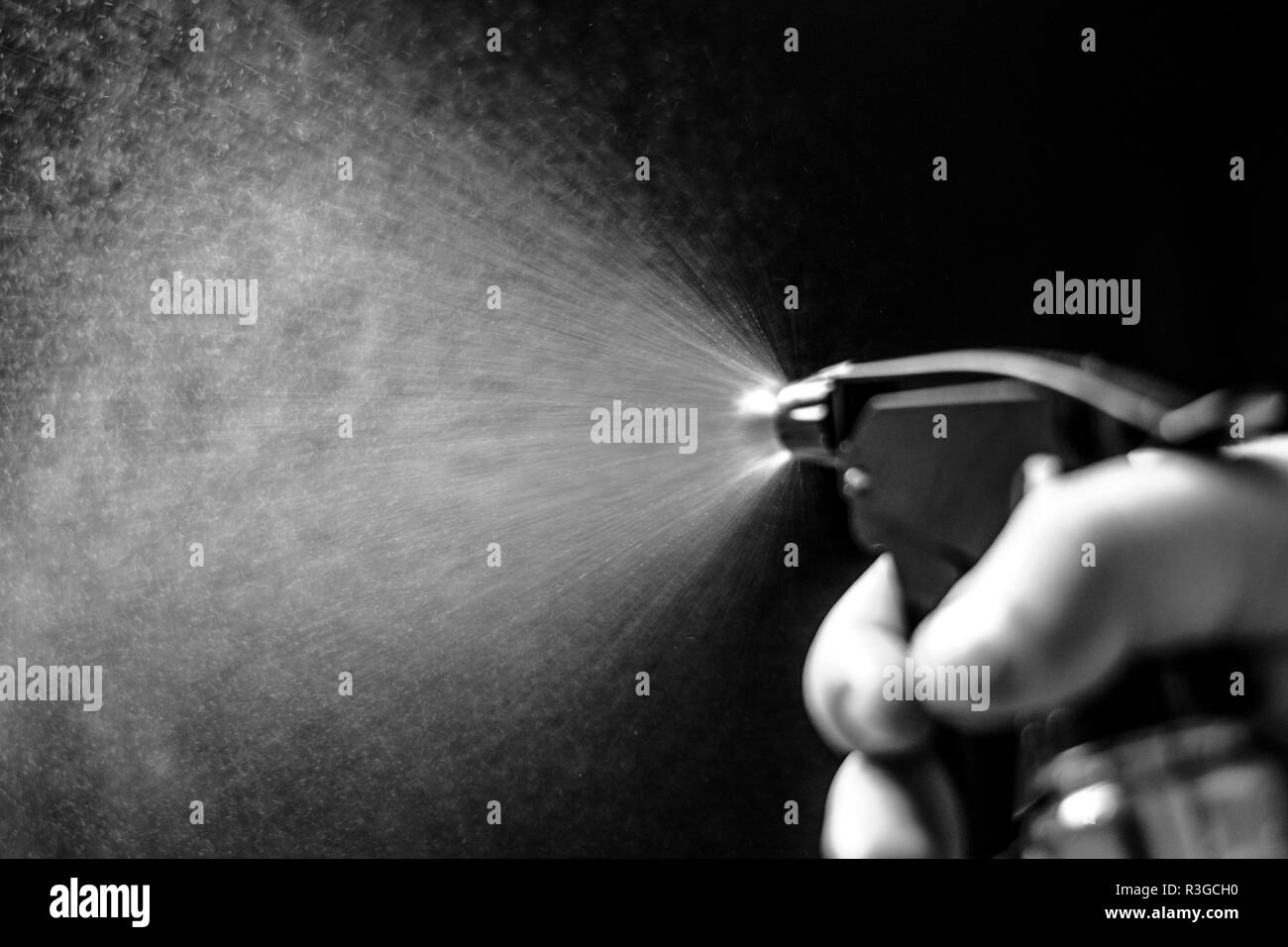 Water jet spraying on black background Stock Photo Alamy