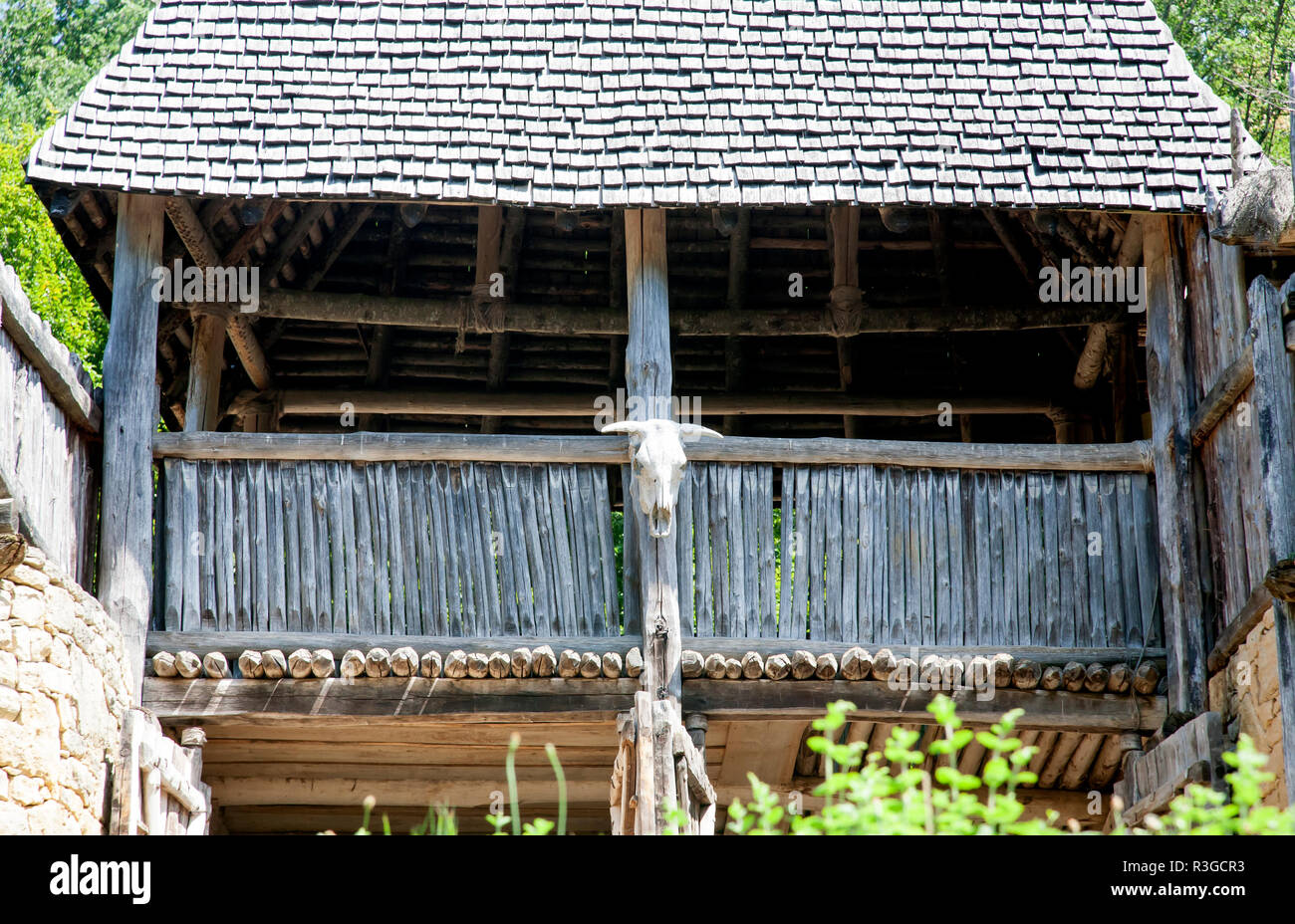 rough wooden roofed balcony with cow's skull nailed to the front of it. Stock Photo